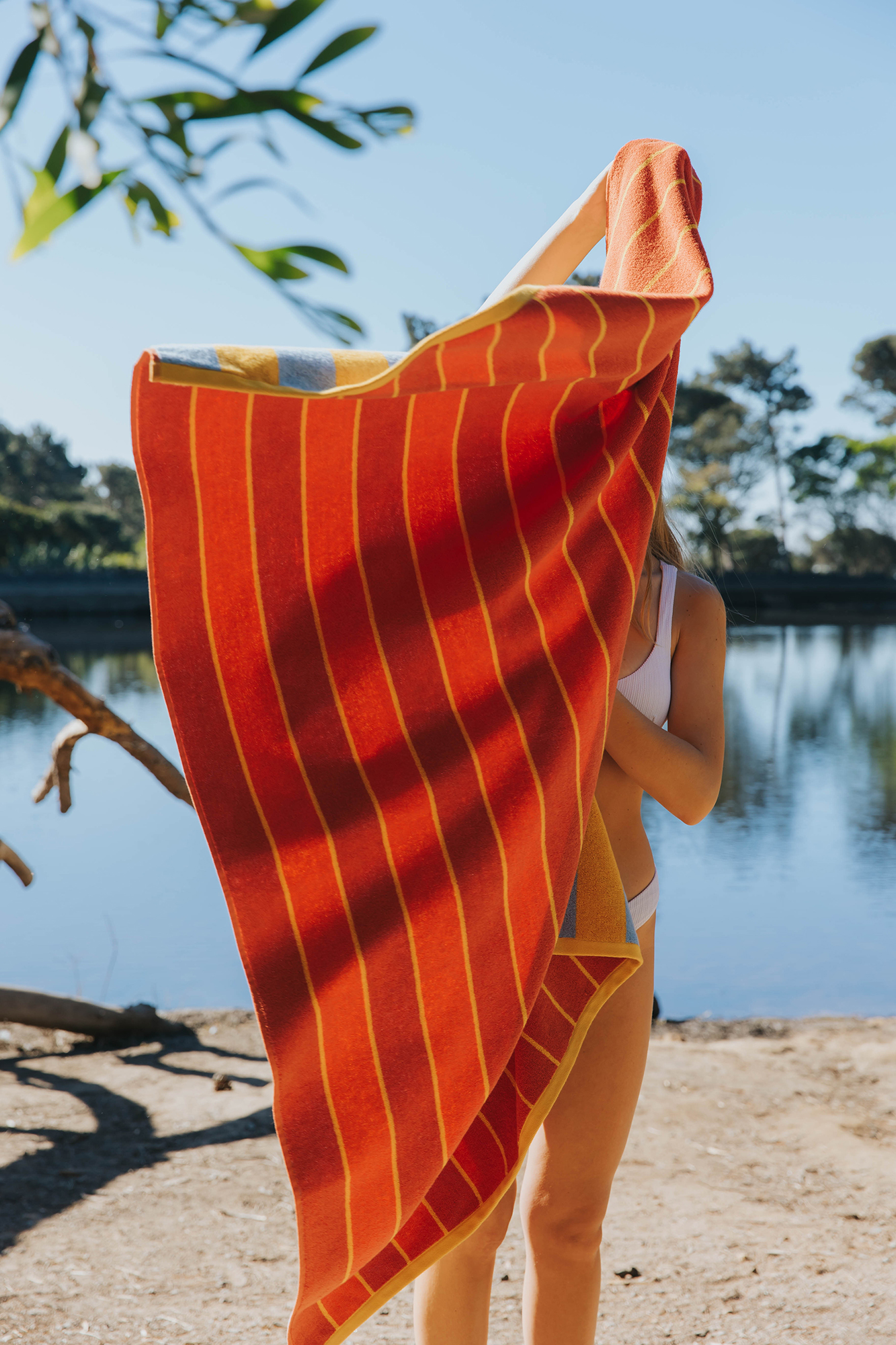 torres-novas-pena-reversible-beach-towels-vertical-stripes-model-yellow-blue-orange-1